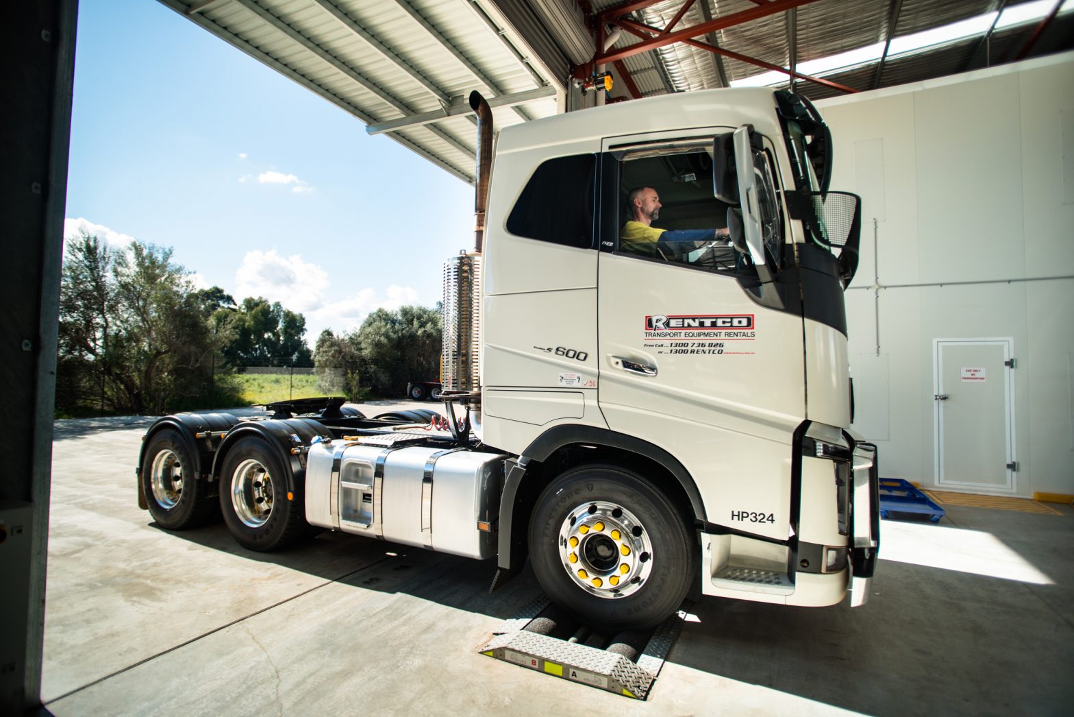 An employee drives a prime mover truck